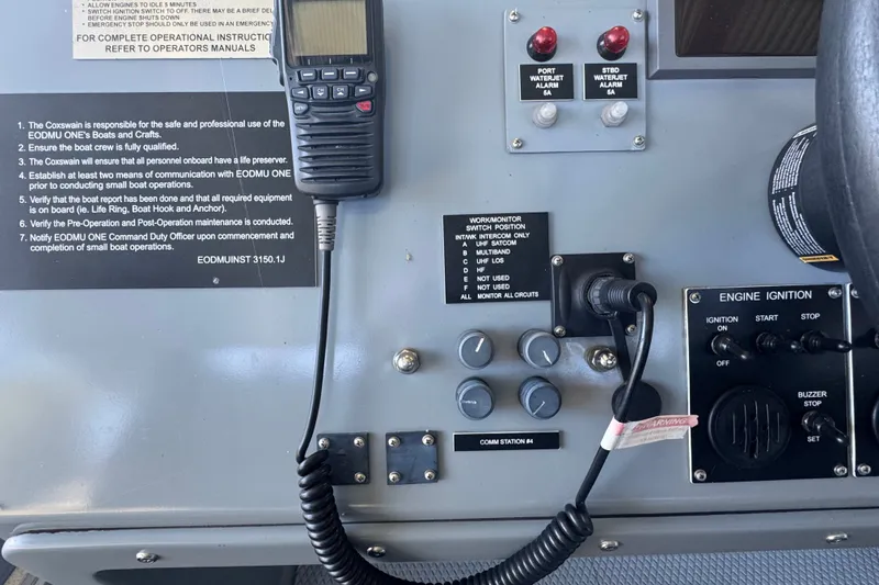 Slide: The Image of Control panel of a 2004 Zodiac Milpro Hurricane boat with communication and ignition systems. - 25