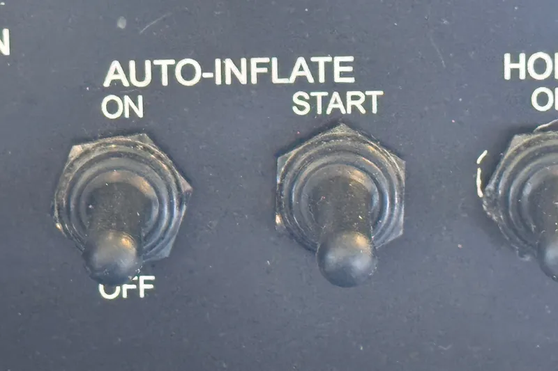 Slide: The Image of Close-up of control panel switches on a 2004 Zodiac Milpro Hurricane boat. - 19