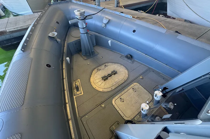 Slide: The Image of 2004 Zodiac Milpro Hurricane boat interior with durable flooring and secure fittings. - 28