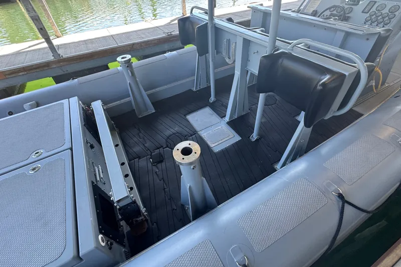 Slide: The Image of 2004 Zodiac Milpro Hurricane boat interior with seating and control panel. - 16