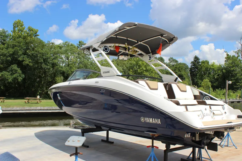 Slide: The Image of 2022 Yamaha Boats 252XE on a lift, showcasing sleek design and modern features. - 22