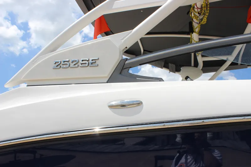 Slide: The Image of 2022 Yamaha Boats 252XE, sleek design with modern features, under a clear blue sky. - 16