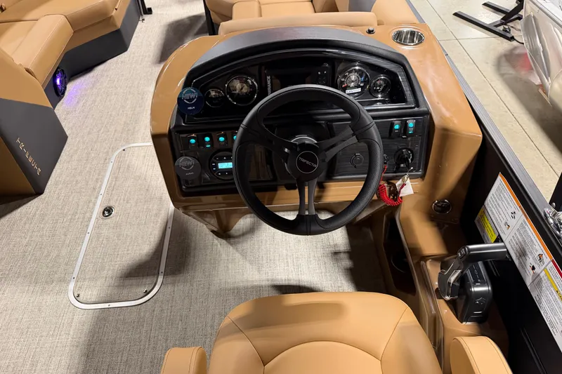 Slide: The Image of Steering console of 2027 Trifecta 24 RFLE boat with tan seating and modern controls. - 14