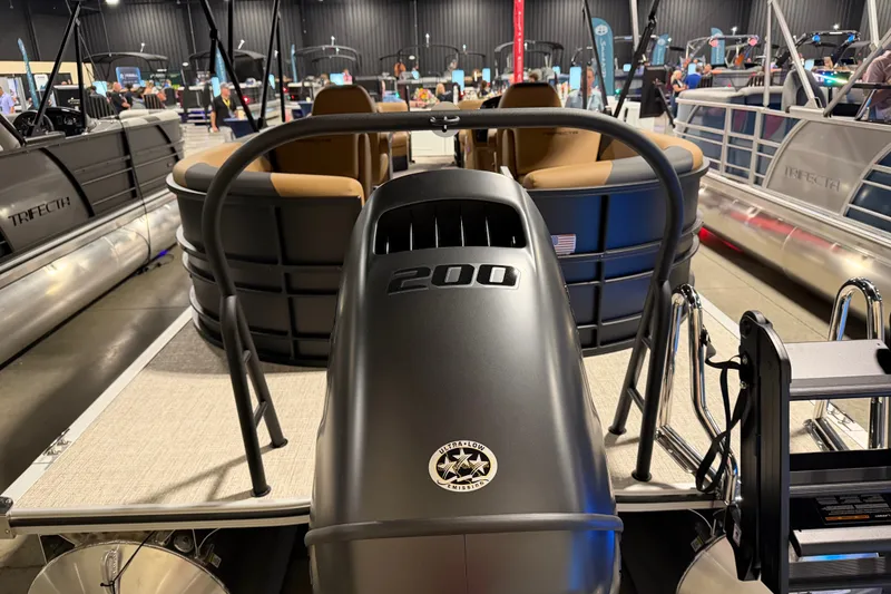 Slide: The Image of 2027 Trifecta 24 RFLE pontoon boat displayed indoors, featuring a powerful engine. - 18