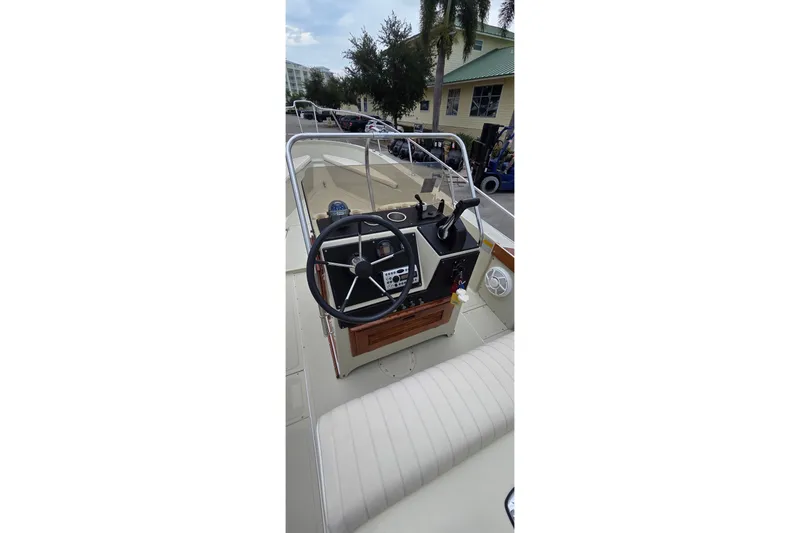 Slide: The Image of 1986 Boston Whaler Outrage 20 boat cockpit with steering wheel and control panel. - 22