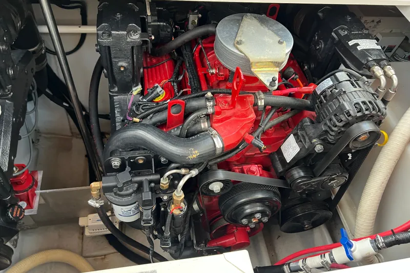 Slide: The Image of Engine compartment of a 2003 Four Winns 298 Vista boat, featuring a red engine. - 26