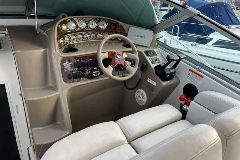 Slide: The Image of 2003 Four Winns 298 Vista boat cockpit with steering wheel and control panel. - 10