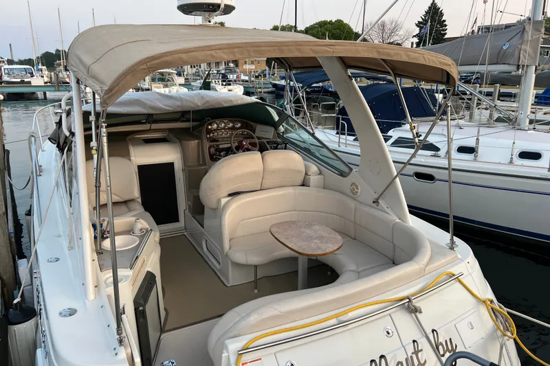 Slide: The Image of 2003 Four Winns 298 Vista boat with beige interior, docked at a marina. - 2