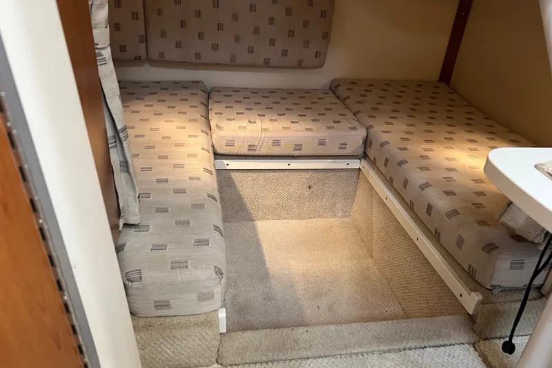 Slide: The Image of Interior cabin of 2003 Four Winns 298 Vista boat with cushioned seating. - 22