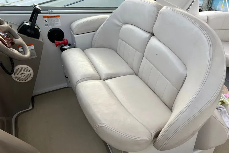 Slide: The Image of 2003 Four Winns 298 Vista boat interior with white leather seating and steering wheel. - 13