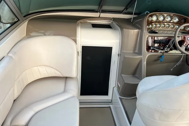 Slide: The Image of Interior of 2003 Four Winns 298 Vista boat with white seating and control panel. - 11