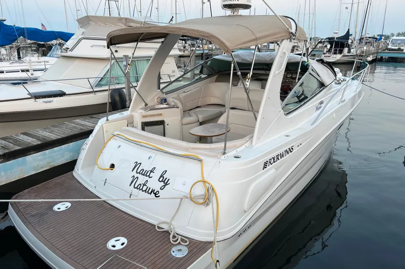 Slide: The Image of 2003 Four Winns 298 Vista boat docked, featuring spacious seating and elegant design. - 3