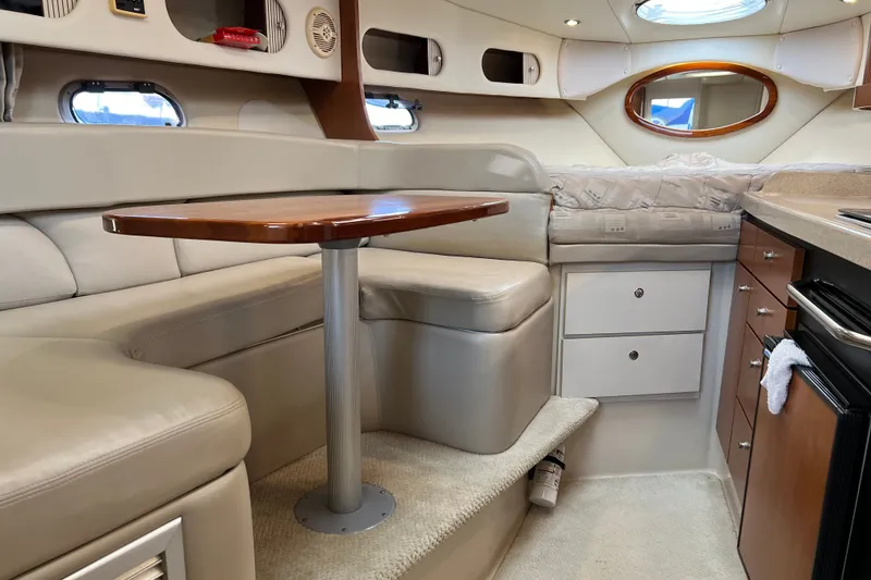 Slide: The Image of Interior of 2003 Four Winns 298 Vista boat with seating, table, and kitchenette. - 16