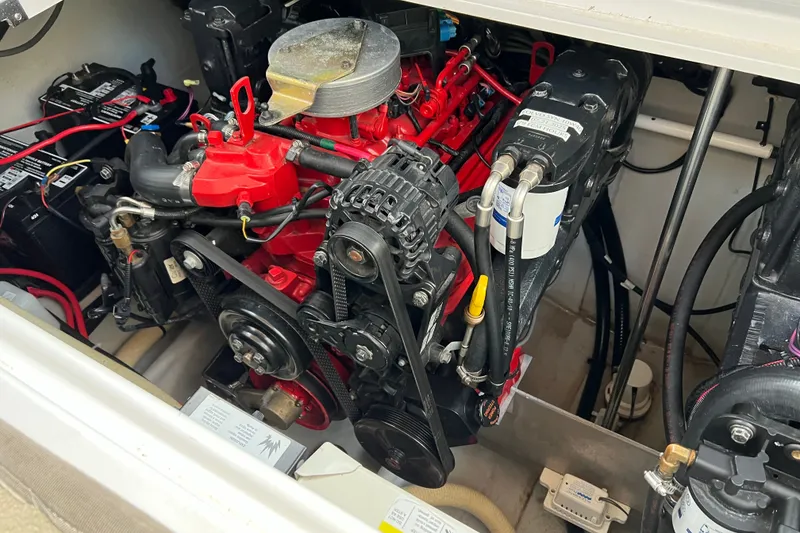 Slide: The Image of Engine compartment of a 2003 Four Winns 298 Vista boat, showcasing detailed mechanical components. - 27
