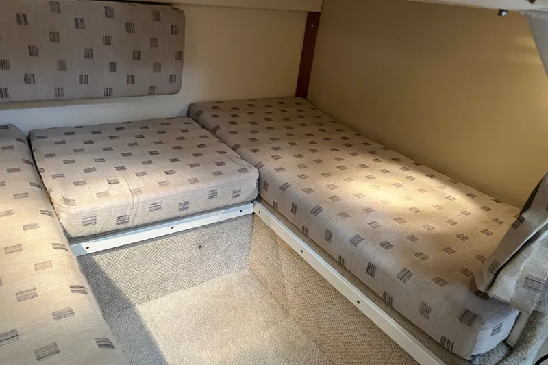 Slide: The Image of Interior cabin of 2003 Four Winns 298 Vista boat with patterned cushions. - 23