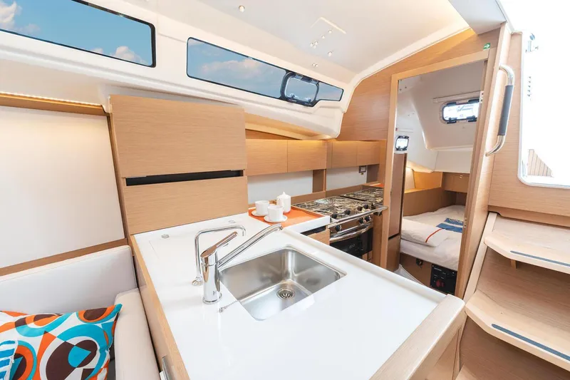 Slide: The Image of Manufacturer Provided Image: Modern interior of 2026 Jeanneau Sun Odyssey 350 yacht with kitchen and cozy cabin. - 11