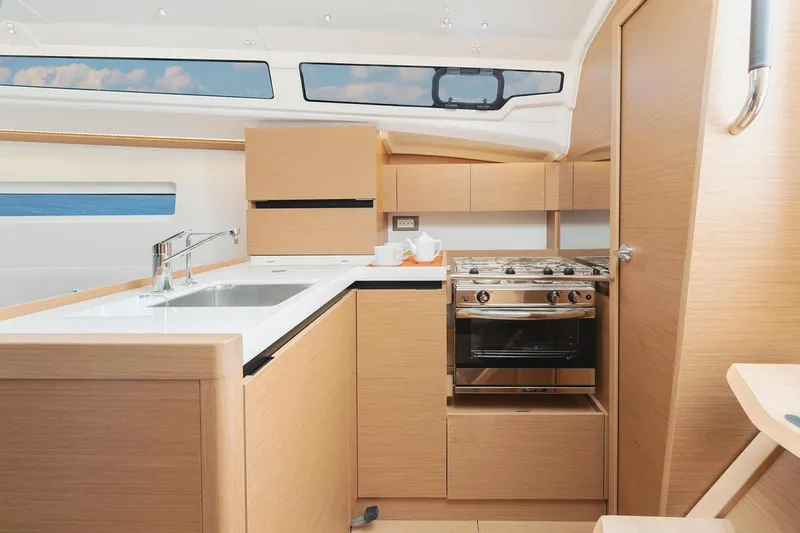 Slide: The Image of Manufacturer Provided Image: Modern kitchen interior of 2026 Jeanneau Sun Odyssey 350 yacht, featuring sleek cabinetry and appliances. - 10