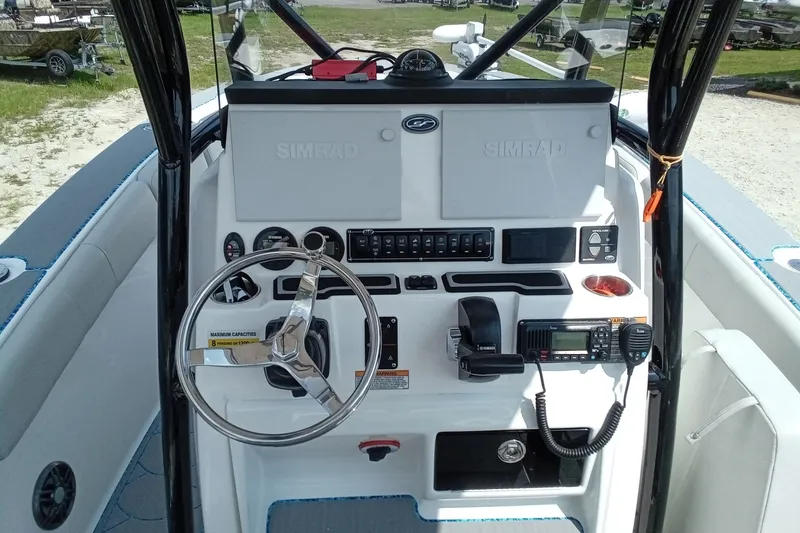 Slide: The Image of 2022 Sea Fox 228 Commander boat dashboard with steering wheel and navigation controls. - 6