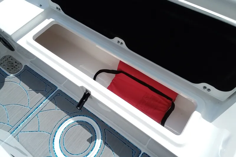 Slide: The Image of Storage compartment on 2022 Sea Fox 228 Commander boat with red life jacket inside. - 5