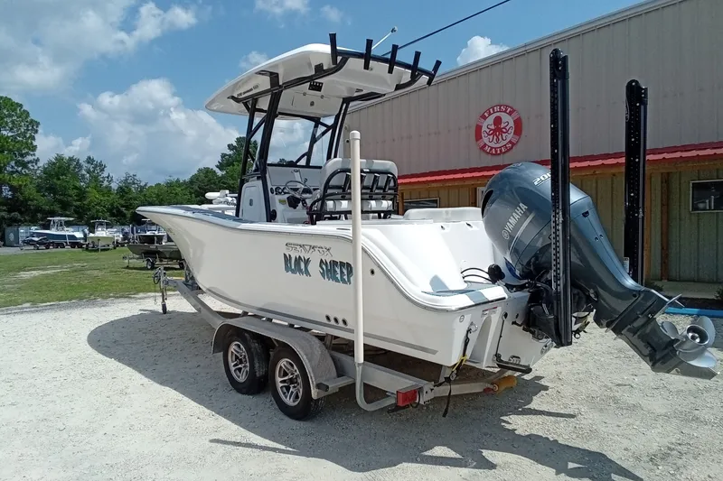 Slide: The Image of 2022 Sea Fox 228 Commander boat on trailer, featuring Yamaha engine, parked outdoors. - 44