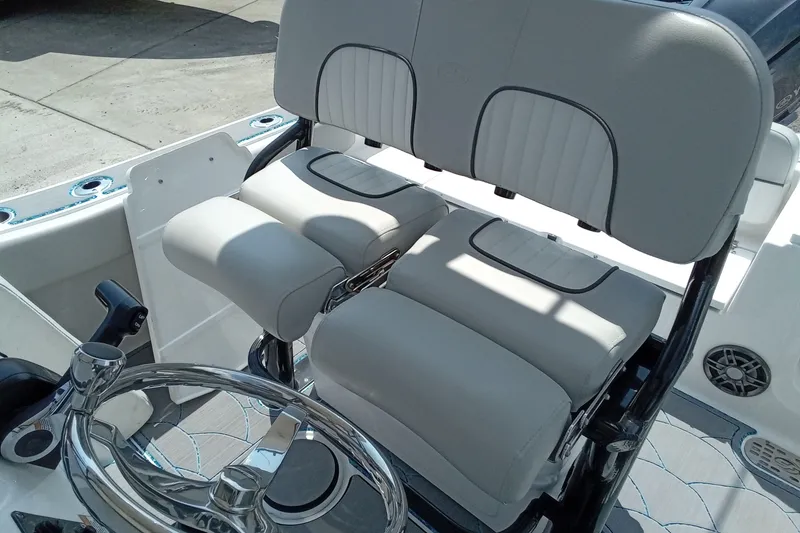 Slide: The Image of 2022 Sea Fox 228 Commander boat interior with cushioned seating and steering wheel. - 19