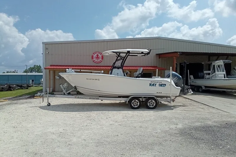Slide: The Image of 2022 Sea Fox 228 Commander boat on trailer outside a warehouse under a cloudy sky. - 38