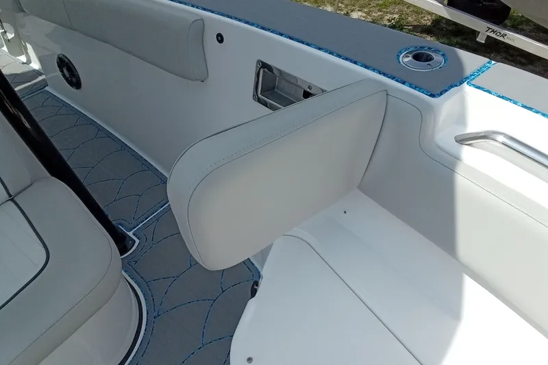 Slide: The Image of 2022 Sea Fox 228 Commander boat interior with cushioned seating and sleek design. - 18