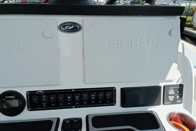 Slide: The Image of 2022 Sea Fox 228 Commander dashboard featuring Simrad electronics and Yamaha controls. - 9