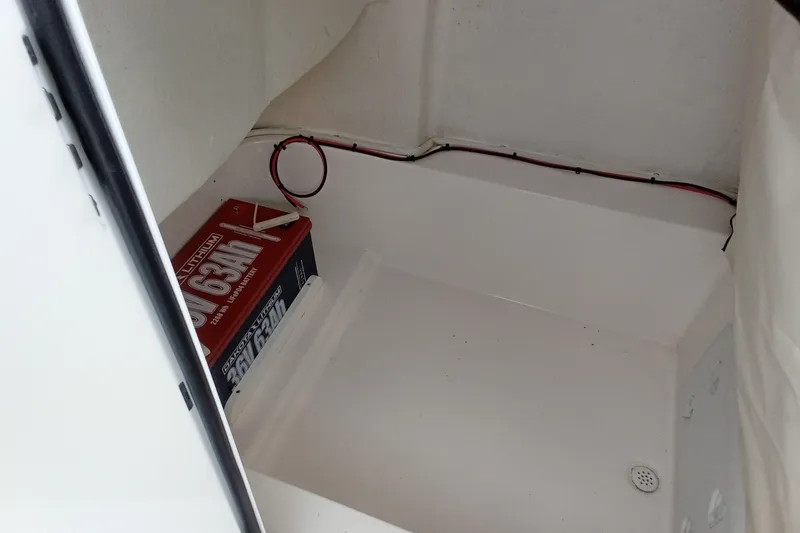 Slide: The Image of Battery compartment of 2022 Sea Fox 228 Commander boat, featuring a 63Ah lithium battery. - 21