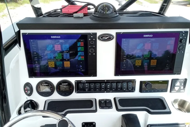 Slide: The Image of 2022 Sea Fox 228 Commander dashboard with dual Simrad displays and control panel. - 30