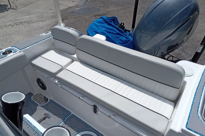 Slide: The Image of 2022 Sea Fox 228 Commander boat interior with white seating and outboard motor. - 22
