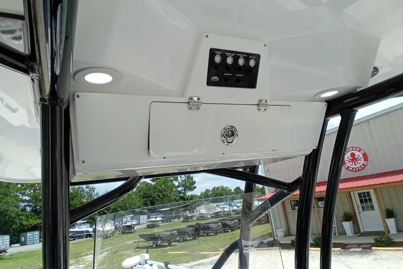 Slide: The Image of 2022 Sea Fox 228 Commander boat console with controls and storage compartment. - 34