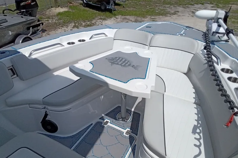 Slide: The Image of 2022 Sea Fox 228 Commander boat interior with seating and table, featuring a fish design. - 26