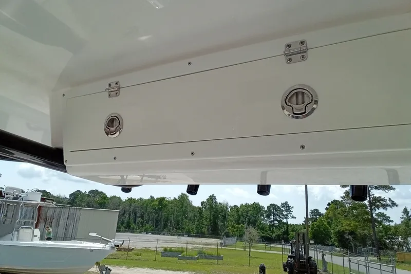 Slide: The Image of 2022 Sea Fox 228 Commander boat storage compartment with secure latches, outdoor setting. - 32