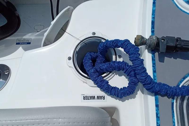 Slide: The Image of 2022 Sea Fox 228 Commander boat with blue hose connected to raw water inlet. - 27
