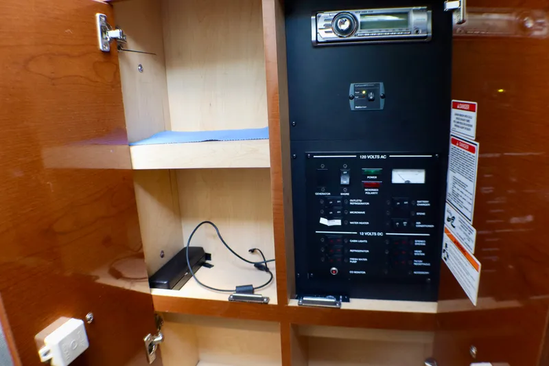 Slide: The Image of Electrical panel inside a 2010 Sea Ray Sundancer 260 boat cabinet. - 46