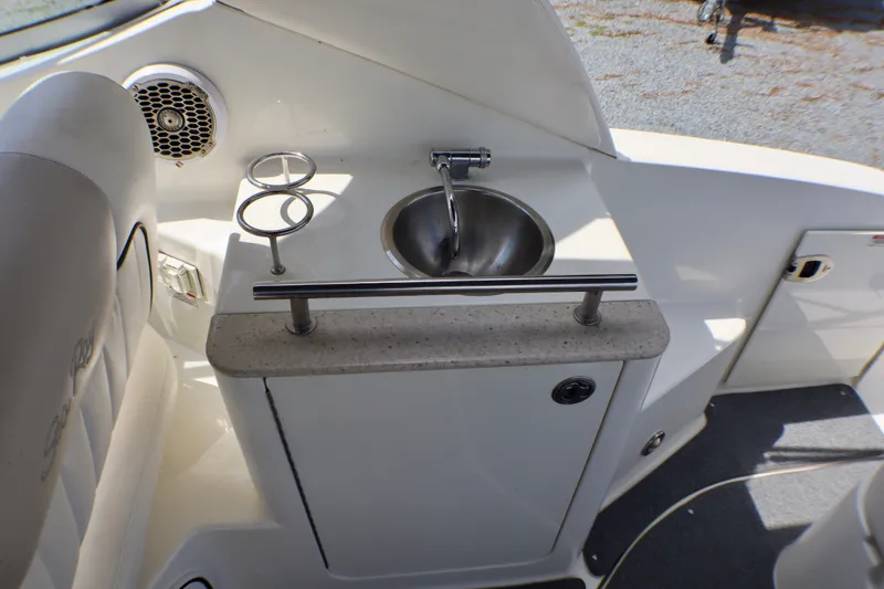 Slide: The Image of 2010 Sea Ray Sundancer 260 boat interior with sink and cup holders. - 21
