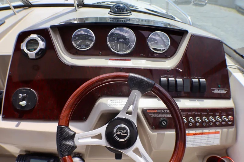 Slide: The Image of Dashboard of a 2010 Sea Ray Sundancer 260 boat with gauges and controls. - 15