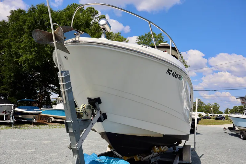 Slide: The Image of 2010 Sea Ray Sundancer 260 boat on trailer, parked outdoors under a blue sky. - 6