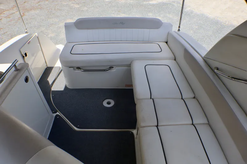 Slide: The Image of Interior seating of 2010 Sea Ray Sundancer 260 boat, featuring white cushioned benches. - 31