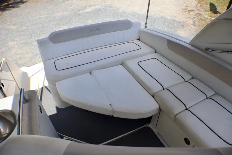 Slide: The Image of 2010 Sea Ray Sundancer 260 boat interior with white cushioned seating arrangement. - 35