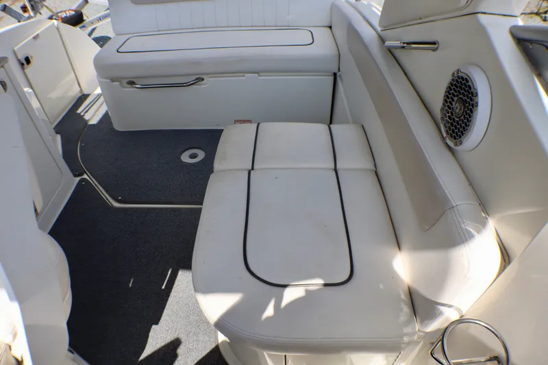 Slide: The Image of Interior seating of 2010 Sea Ray Sundancer 260 boat with white upholstery and speaker. - 11