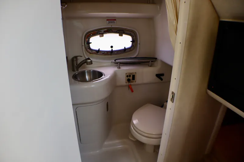 Slide: The Image of Interior of 2010 Sea Ray Sundancer 260 boat bathroom with sink and toilet. - 44