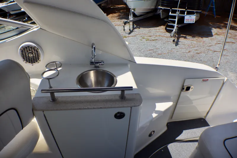 Slide: The Image of Interior view of a 2010 Sea Ray Sundancer 260 boat featuring a compact sink and cup holders. - 49