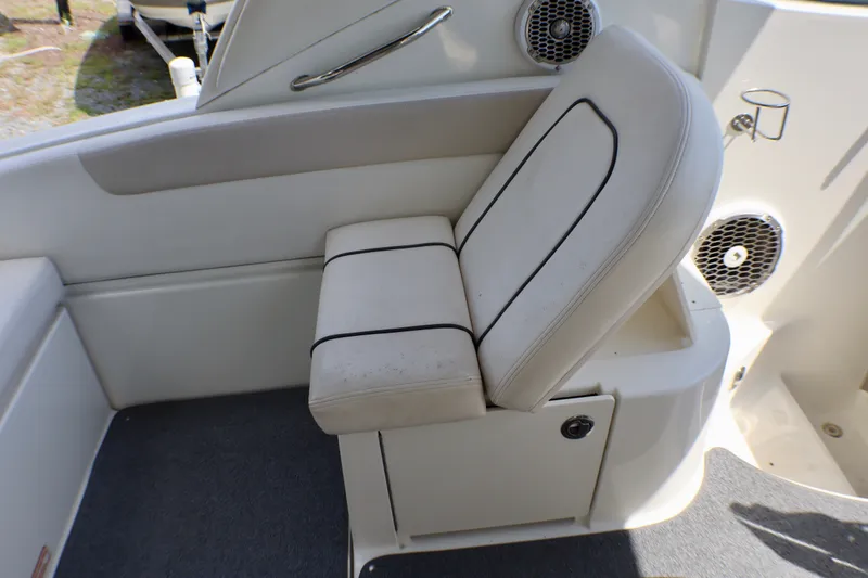 Slide: The Image of 2010 Sea Ray Sundancer 260 interior with white seating and speaker system. - 30