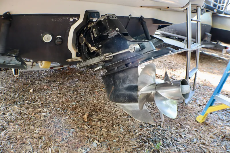 Slide: The Image of 2010 Sea Ray Sundancer 260 boat propeller and stern drive on dry land. - 57
