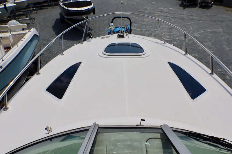 Slide: The Image of 2010 Sea Ray Sundancer 260 boat deck with sleek design and windows. - 17