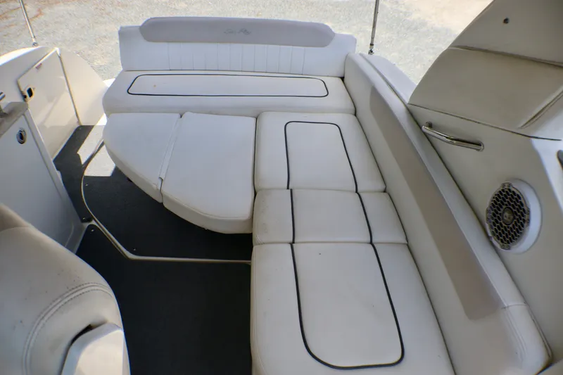 Slide: The Image of Interior seating of a 2010 Sea Ray Sundancer 260 boat, featuring white cushioned seats. - 36
