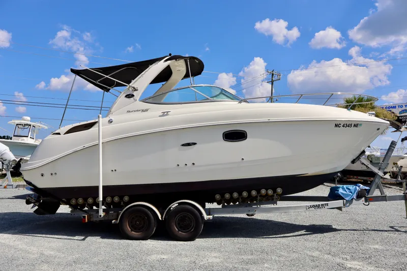The Image of 2010 Sea Ray Sundancer 260 boat on trailer under blue sky. - 0