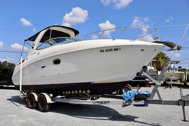 Slide: The Image of 2010 Sea Ray Sundancer 260 boat on trailer under blue sky. - 8